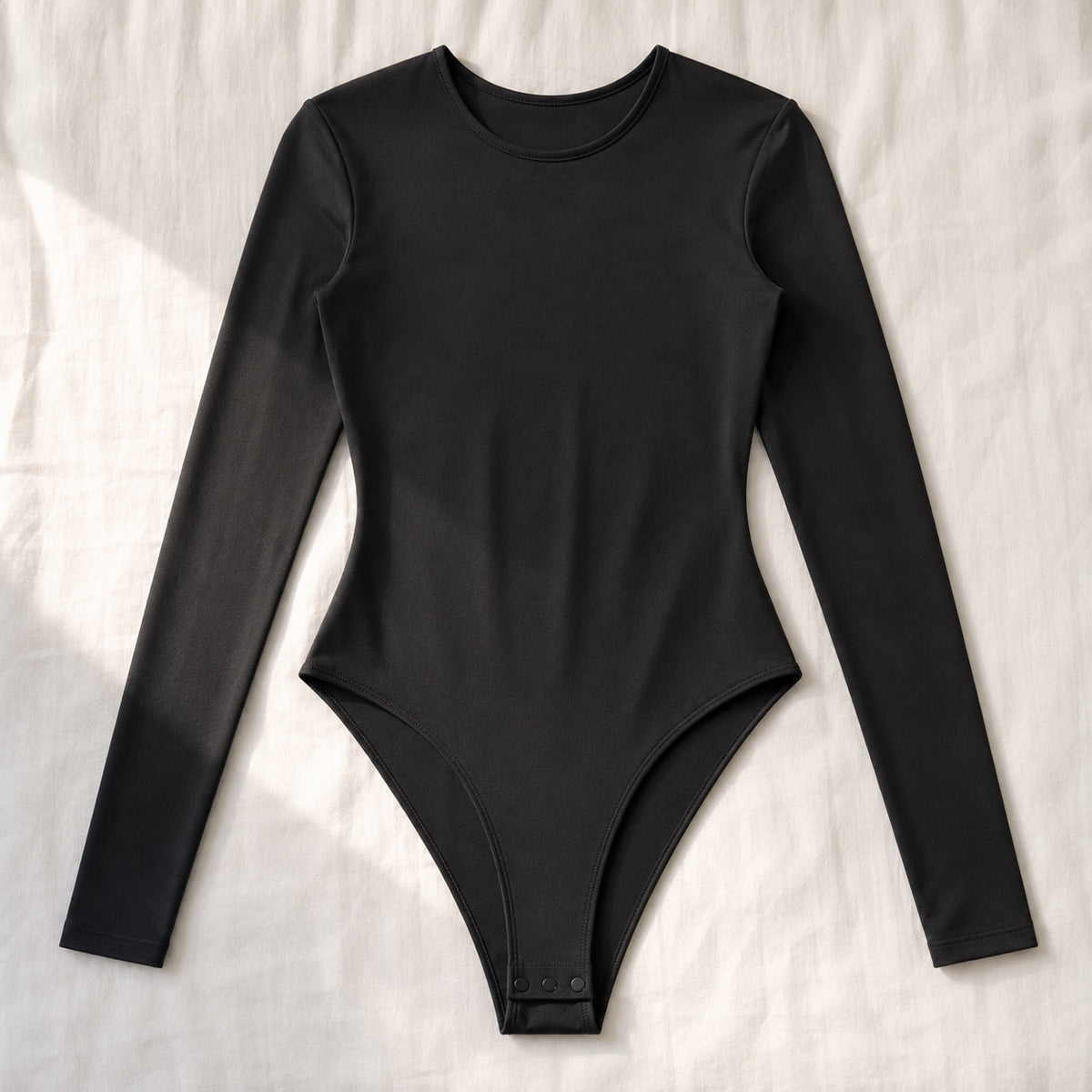 Bourne long-sleeve base layer bodysuit, Long-Sleeve Base Layers — front view, photographed flat.