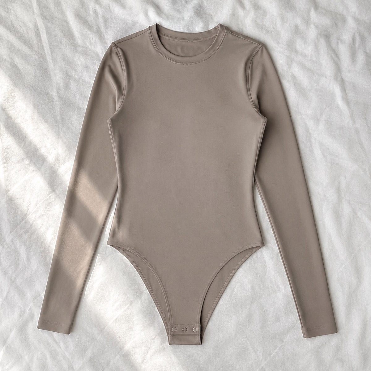 Tilford long-sleeve base layer bodysuit, Long-Sleeve Base Layers — front view, photographed flat.