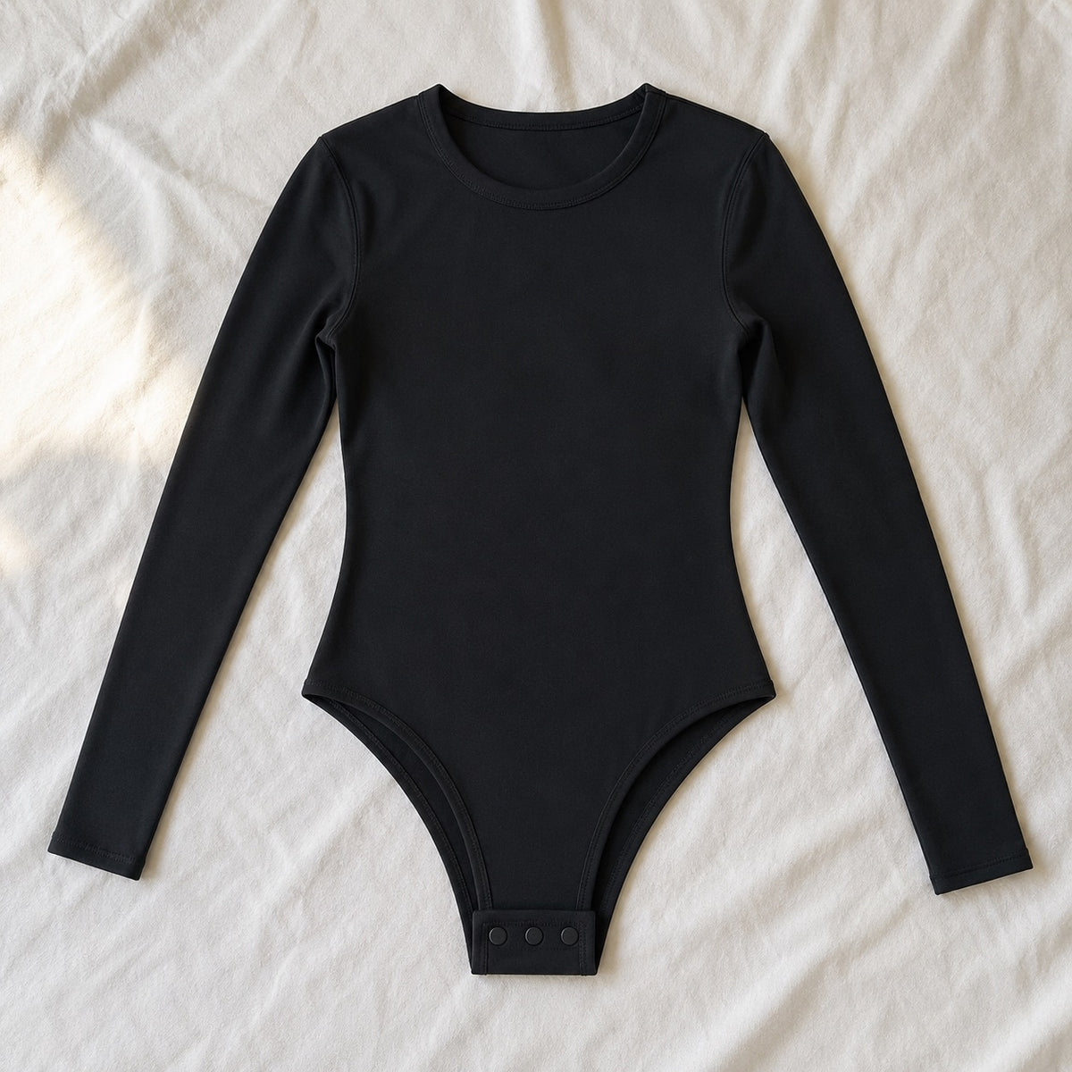 Badshot long-sleeve base layer bodysuit, Long-Sleeve Base Layers — front view, photographed flat.